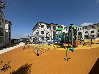 A playground with a swing set and a climbing frame.